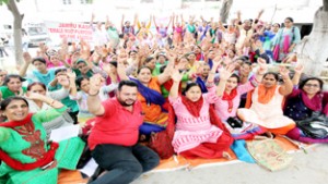 FMPHWs sitting on protest dharna in the premises of DHS Jammu. -Excelsior/Rakesh