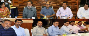 DyCM, Dr Nirmal Singh alongwith Finance and Industries Ministers interacting with members of various industrial associations at Jammu on Tuesday.