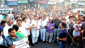 Participants during candle light protest march at Jammu on Friday.