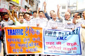 Traders and residents of Jammu West raising slogans in support of their demands on Wednesday.