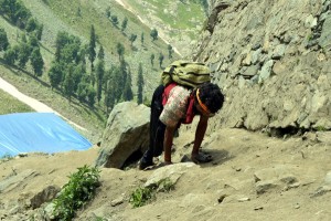 A handicapped pilgrim crawling towards holy cave on Tuesday. -Excelsior/Sajad Dar