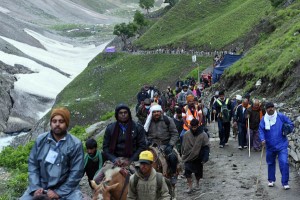 Amarnath pilgrims on way to the holy cave crossing a glacier at Baltal in North Kashmir on Sunday.(UNI)