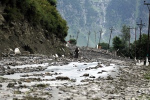 A villager walks on mud road after series of deadly cloudbursts in Kullan and Gagangir villages washed away residential houses along Srinagar - Leh National Highway.