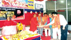 Dignitaries lighting the traditional lamp (right) and a religious guru delivering discourses (left) at Shiv Darhan Temple in Katra.