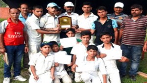 Winners with mementos and certificates posing for group photograph.