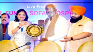 A dignitary presenting memento to Health Minister of Punjab, Surjit Kumar Jyani during a medical conference in Punjab.