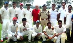 Players of JKP Cricket XI posing for photograph with SSP Traffic Mohan Lal after winning match at GGM Science College cricket ground on Saturday.