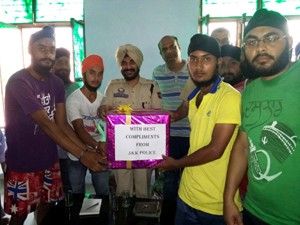 Youth receiving sports kits from RS Pura Police at Bishnah on Tuesday.