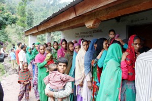 People standing in a queue outside medical camp organized by Army at village Beena in Reasi.
