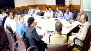 Chief Secretary Iqbal Khandey chairing a meeting at Srinagar on Friday.