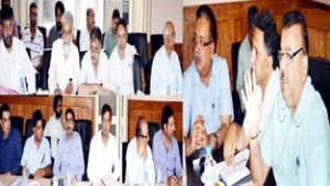 Minister for Industries Chander Parkash Ganga chairing a meeting at Srinagar on Wednesday.