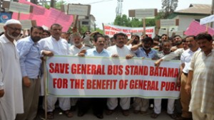 Senior members of General Bus stand of Batamaloo  protesting against Government order to shift General Bus terminal to Parimpora  in Srinagar on Tuesday.   	-Excelsior/ Amin War