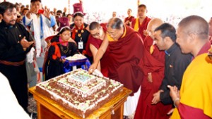 Sakya Rinpoche cutting birthday cake during a function in connection with birthday of Dalai Lama at Leh on Monday.