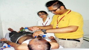 Doctor examining a patient at Health Awareness Camp at Jyotipuram on Friday.