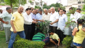 Children planting saplings as part of Vanmahotsav celebrations at a park in Gandhi Nagar, Jammu on Tuesday. 