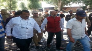 Minister for Industries Chander Parkash during visit to cloudburst hit areas.