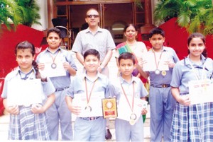 Students of KC Public School who won 2nd Place in National Youth Games posing for a group photograph alongwith School Principal, Amarendra Kumar Mishra.