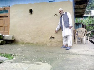 A civilian shows bullet marks on his house at Sabzian in Poonch on Thursday.             —Excelsior/Harbhajan