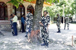 CRPF jawans stand guard near Shrine in Tujjar Sharief area of Sopore on Tuesday. -Excelsior/ Aabid Nabi