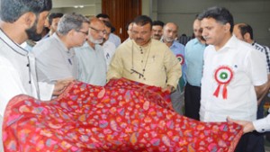 Minister for Industries Chander Parkash Ganga flanked by MoS, Mohammad Ashraf Mir at a handloom stall at SKICC on Friday.
