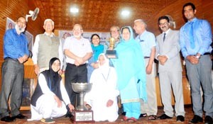 Winners of debate competition posing alongwith dignitaries at Kashmir University on Saturday.