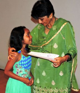 Bindya Narain, Chairperson, FWO encouraging talented child.