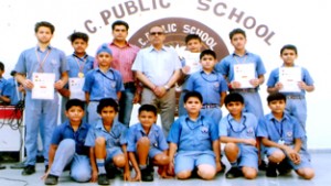 Karatekas of KC Public School posing alongwith School Principal, Amarendra Kumar Mishra and coach Ambedkar Gupta on Friday.