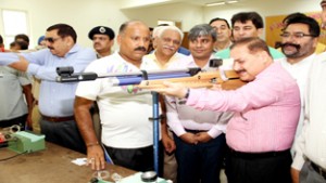 Divisional Commissioner Jammu, Dr Pawan Kotwal aiming target while inaugurating Shooting Championship in Jammu on Friday.  