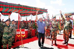 Defence Minister Manohar Parrikar and Army chief Gen Dalbir Singh Suhag raise hands after addressing troops in Leh on Sudnay.