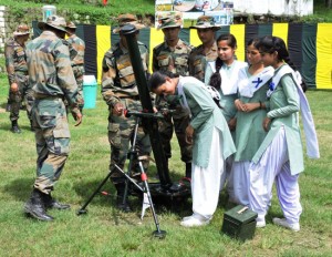 Students looking the equipment of Indian Army during its display.