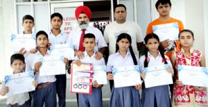 Medal winners and coach Sanjay Tutoo posing for photograph with Principal KCS Mehta.  