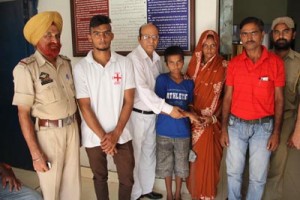 GRP men handing over run-away boy to parents.