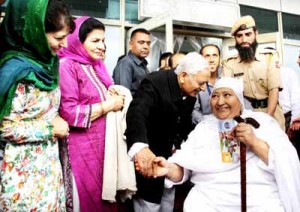 Chief Minister, Mufti Mohd Sayeed interacting with a Haj pilgrim at Srinagar Airport on Monday.