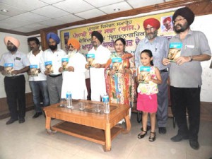 A book being released during a function organised by Punjabi Lekhak Sabha.