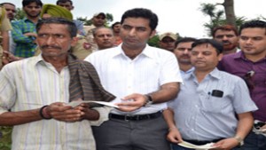 DDC, Dr Shahid Iqbal Choudhary handing over a relief cheque to a beneficiary in Majalta Tehsil on Monday.