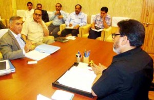 Minister for R&B, Syed Mohammad Altaf Bukhari chairing a meeting at Srinagar on Wednesday.