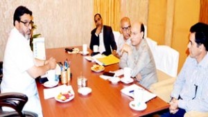 Minister for R&B, Syed Mohammad Altaf Bukhari chairing a meeting at Srinagar on Monday.