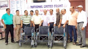 The members of National United Front handing over wheel-chairs to Railway authorities at Jammu on Friday. 