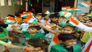 Students carrying National Flag during I-Day celebrations.