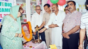 Senior BJP leader, Yudhvir Sethi lighting a lamp during a function at Jammu on Wednesday.