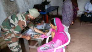 An army doctor attending a patient during medical camp.