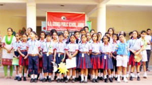 Winners of Hindi Poem Recitation Competition posing along with dignitaries at GD Goenka Public School in Jammu.