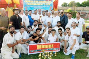 Winners posing for a group photograph alongwith chief guest and other dignitaries at KC School ground in Jammu on Sunday. 