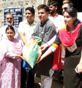 MLA, Ravinder Raina distributing ration in Nowshera on Thursday.