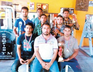 Players and coach of National Champion Gym posing for a group photograph during felicitation function on Tuesday.