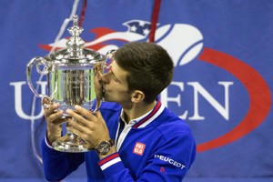 Novak Djokovic of Serbia kisses the U.S. Open trophy after defeating Roger Federer of Switzerland in men's singles final match at the U.S. Open Championships tennis tournament in New York. (UNI)