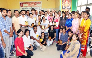 Meritorious students posing for a group photograph during felicitation function organized by Vishwakarma Sabha in Jammu. 