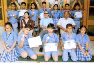 Swimmers of KC Public School posing alongwith Principal Amarendra Mishra on Tuesday.
