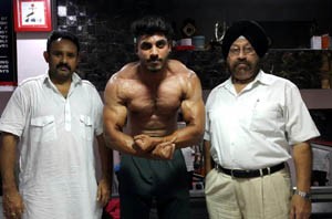 Body Builder Dhananjay Singh Charak posing for a photograph alongwith office bearers of the Association.