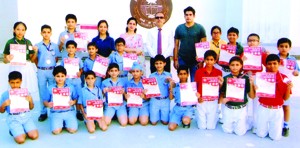 Karatekas posing for a group photograph alongwith Principal Amarendra Kumar Mishra at KC Public School.